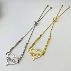 Detail of adjustable heart bracelets with elephant relief in gold and silver finish