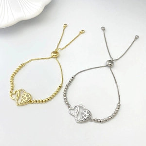 Close-up of adjustable bead chain bracelets with interlocking mesh and crystal hearts