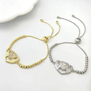 Detail of adjustable MOM heart bracelets with crystal wings in gold and silver finish