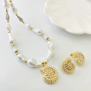 Baroque pearl necklace and shell earring set with golden snail design in vintage style