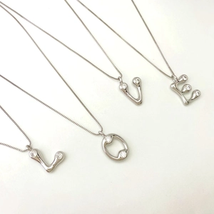 Silver alphabet LOVE pendant necklace set with liquid metal texture and zircon stones