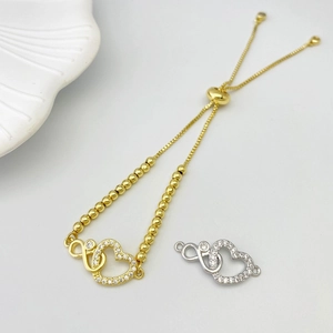 Detail of infinity double heart bracelet with cubic zirconia in gold and silver finish