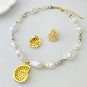 Baroque style jewelry set featuring pearl necklace and golden conch shell stud earrings