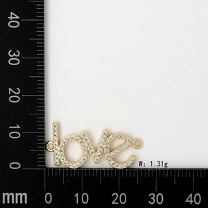 Macro shot of 1.31g gold-plated LOVE charm connector with cubic zirconia for jewelry