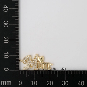 Detail view of MOM letter pendant with inlaid rhinestones and gold heart on a measuring scale