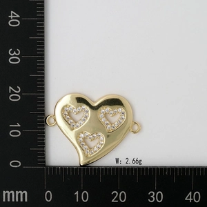 Macro shot of 2.66g gold heart charm with MOM letters and inlaid white zircons