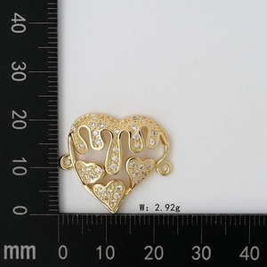Macro shot of 2.92g golden heart connector charm with MOM lettering and zircon micro-paving