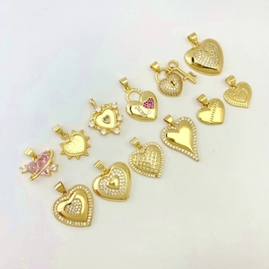 Detailed collection of twelve heart-shaped gold-plated brass pendants with zircon inlays