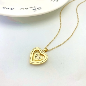 Detailed back view of gold heart pendant showing honeycomb setting and craftsmanship