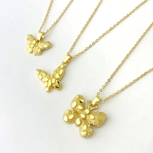 18K gold-plated butterfly necklace with matte wings and fine chain on white background
