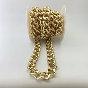 Detaillierte Ansicht der dicken goldenen Herzgliederkette auf einer weißen Spule gewickelt