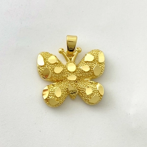 Macro shot of 18K gold butterfly pendant with frosted texture and polished accents