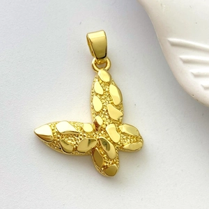 Detail of 18K gold butterfly pendant featuring textured metallic relief and matte finish