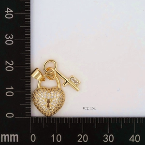 Detailed view of heart lock and key pendants with zircon on scale showing 2.15g weight
