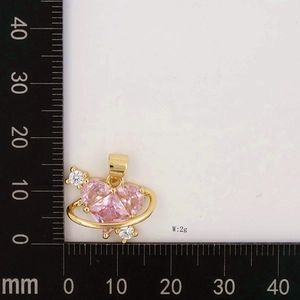 Detail of pink heart pendant with gold ring weighing 2g against a millimeter ruler