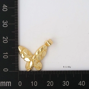 Detailed view of 18K gold butterfly pendant showing 3.60g weight and size measurements