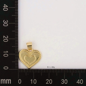 Detailed view of heart pendant with beaded edge and size scale measurements