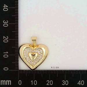 Detailed view of a gold heart pendant with zircon inlay and 24mm ruler measurement
