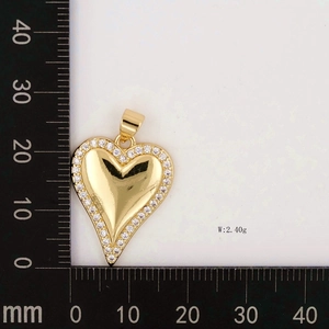 Macro shot of 33mm heart pendant in gold finish with white cubic zirconia setting