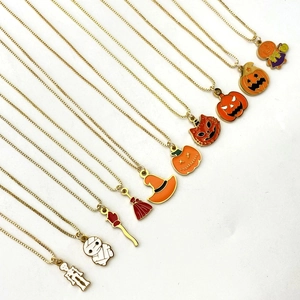 Detail showing 10 gold Halloween charms including pumpkins and ghosts with colorful enamel