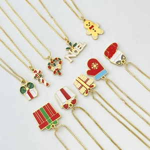 Detailed view of assorted Christmas charms on gold chains with colorful enamel finish