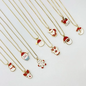 Macro view of Christmas stainless steel pendants with enamel Santa and reindeer charms