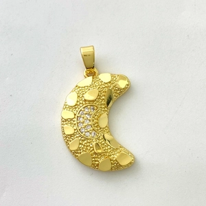 Detailed macro view of 18K gold-plated crescent moon pendant with hammered texture and zircons