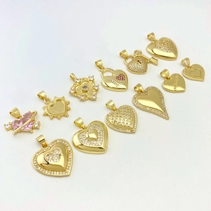 Selection of heart-shaped gold pendants with sparkling cubic zirconia and pink gemstones