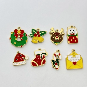 Detail showing 8-piece set of Christmas enamel charms including reindeer and bells