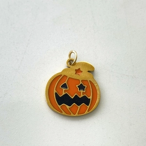Detail of Jack-o'-lantern pendant with orange enamel and gold-plated metal finish