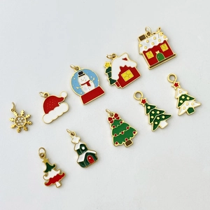 Close-up of assorted enamel Christmas charms including snowflakes and Xmas trees