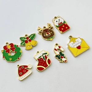 Detailed macro view of festive Christmas enamel charms including reindeer and bells for DIY