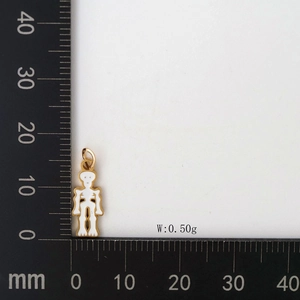Detailed size measurement of a gold skeleton ghost charm pendant on a black caliper