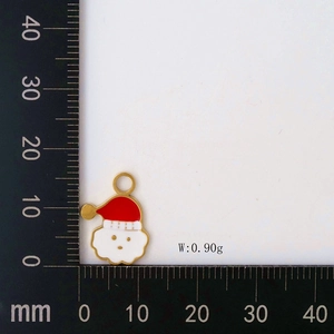 Detail of Santa Claus enamel pendant with dimensions on measuring mat and 0.90g weight