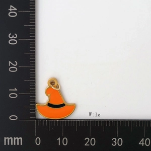 Detail of orange witch hat pendant with gold metal edges and black ribbon decoration