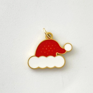 Close-up of Santa hat pendant with red and white enamel on a golden stainless steel frame