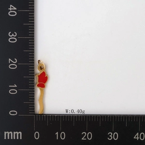 Detailed size measurement of golden rose pendant with red enamel on a black scale board