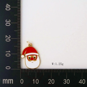 Macro view of Christmas Santa pendant with red enamel details and measuring scale