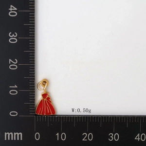 Detail view of small red enamel dress pendant with gold metal edges showing weight 0.50g