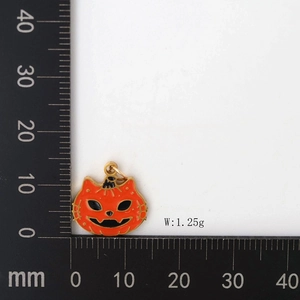 Macro shot of a pumpkin cat face pendant showing 15mm scale and 1.25g weight details