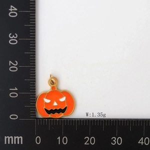 Size measurement of a small orange enamel pumpkin pendant with dimensions of 15mm by 17mm