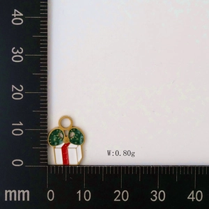 Macro view of Christmas gift box pendant measuring 13mm height with ruler scale