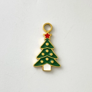 Detail showing a Christmas tree enamel pendant with gold trim and festive decorations