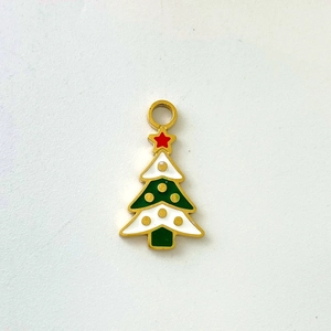 Detail of Christmas tree pendant with green, white, and red enamel in golden finish