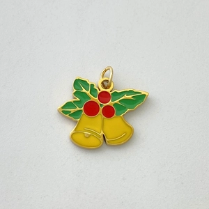 Detail of Christmas bell pendant featuring red berries and green holly leaves on alloy