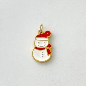 Detail of Christmas snowman pendant with red and white enamel on gold stainless steel