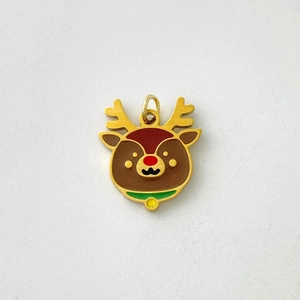 Close-up of golden reindeer pendant with colorful enamel details and yellow bell charm