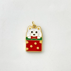 Close-up of a festive enamel cat pendant inside a red gift box for Christmas necklace