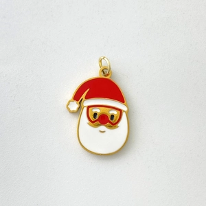 Macro view of Santa Claus enamel pendant with golden trim and white beard detail