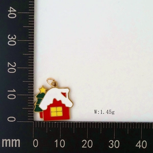 Detailed view of enamel Christmas house pendant with scale measuring 15mm and 1.45g